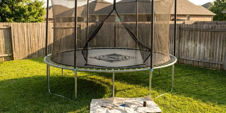 trampoline mat repair: trampoline with safety net in a backyard